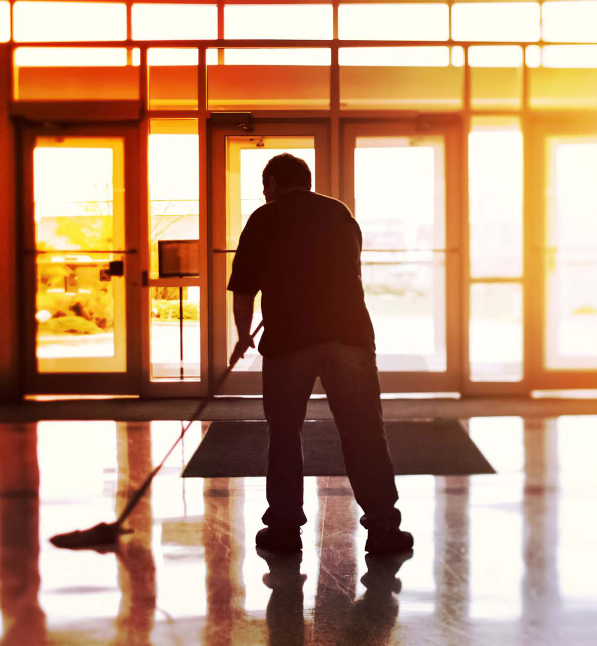 Gebäudereiniger beim Bodenwischen